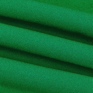 Macro detail of emerald green high-density knitted fabric showing premium soft texture