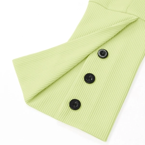Detail view of lime green ribbed knit texture with decorative black buttons and side slit