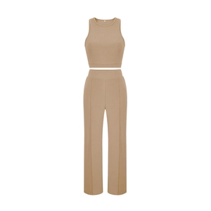 Detail of camel two-piece sleeveless top and high-waisted wide-leg pants with front seam