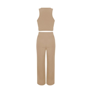 Detailed view of camel ribbed sleeveless top and high-waist wide-leg lounge pants