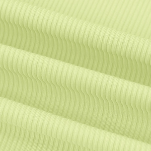 Detailed macro view of light green ribbed knit fabric texture for a buttoned dress