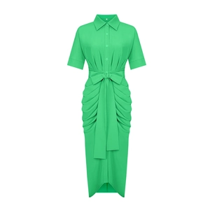 Detail of green polo neck midi dress with large bow waist tie and pleated hem texture