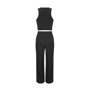 Detail view of black sleeveless crop top and high waist straight pants set