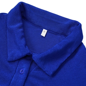 Detailed macro view of a blue knit dress polo collar with a size S label and button