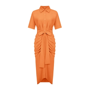 Detail of orange short-sleeved polo collar shirt dress with pleated waist and tied bow