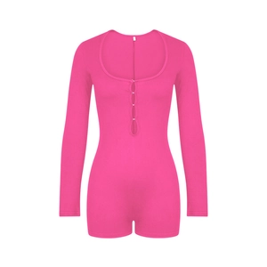 Detail of pink long sleeve romper featuring a deep U-neck and silver hook-and-eye front closure