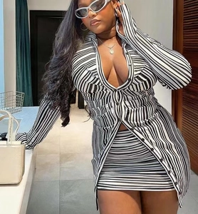 Detail of black and white striped knit long-sleeve shirt and matching mini skirt set