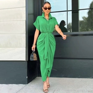 Detail of green polo neck midi dress featuring pleated waist and tie-up belt design