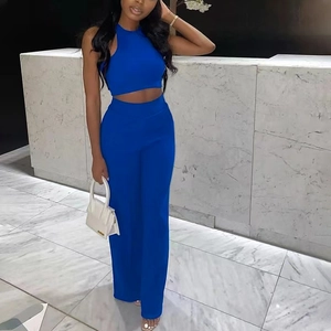 Detail of royal blue sleeveless halter crop top and high-waist wide-leg trousers set