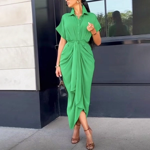 Detail of a bright green short-sleeved shirt dress with waist tie and front buttons