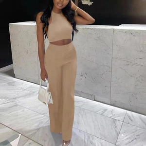 Detail of high-waist wide-leg trousers and sleeveless halter crop top set in khaki