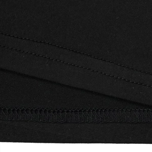 Detail view of double-needle stitching on the hem of a black knitted slim-fit jumpsuit