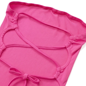 Close-up of fuchsia backless dress featuring cross-tie straps and bow detail