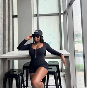 Detail of the slim fit black romper featuring hollow-out metal rings on the U-neckline