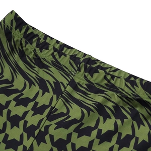 Detail of green and black abstract pattern waist with elastic band and neat stitching