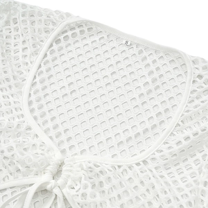 Close-up of white knit mesh fabric with S-size label and drawstring drawstring detail