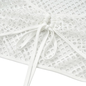 Detail of white mesh knit texture and adjustable drawstring ties on a two-piece set