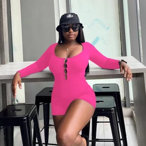 Detail of hot pink long sleeve romper featuring a front cutout with buckle accents
