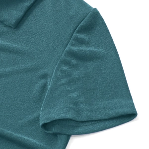 Detailed macro view of teal knitted fabric texture and premium stitching on a dress