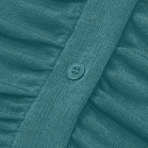 Detail of teal knitted fabric with ribbed texture and matching four-hole resin button