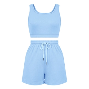 Flat lay of light blue sleeveless crop top and elastic drawstring shorts athletic set