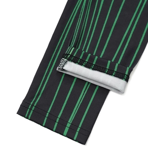 Detail des doppelgenähten Saums am schwarzen Kleid mit grünen vertikalen Streifen