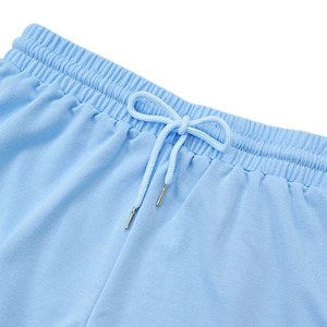 Detail of light blue elastic waistband with drawstring and metal tips for sports shorts
