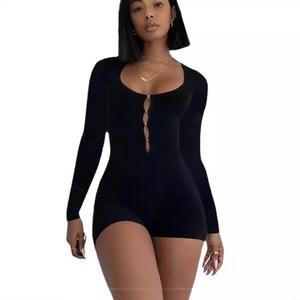 Slim fit black long sleeve romper featuring a deep U-neckline and hollow-out front design