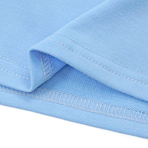 Detail shot of light blue knit fabric showing precise double-needle stitching and inner seams