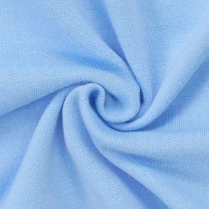 Detailed macro view of light blue knitted cotton fabric showing soft texture and weave