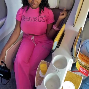 Survêtement de sport rose deux pièces pour femme avec imprimé STARK dans un avion