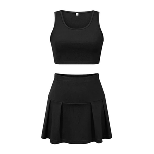 Flat lay of a two-piece black sports set featuring a sleeveless crop top and pleated mini skirt
