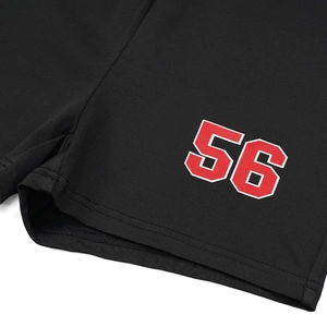Detail of black sports shorts featuring a varsity style red and white number 56 print