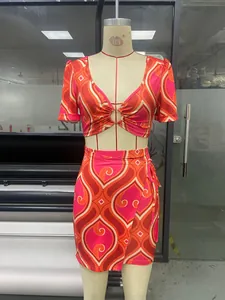 Detail view of the deep V-neck crop top with metal ring buckle and retro swirl pattern