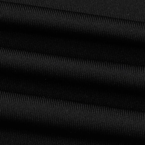 Close-up of premium black elastic knit fabric texture with fine ribbed weave details
