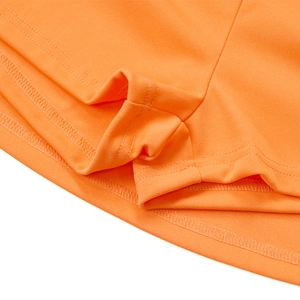 Close-up of vibrant orange athletic fabric showing high-quality double-stitch hem details