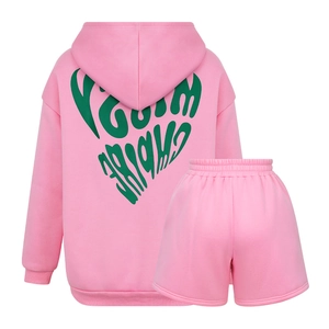 Detail of pink hoodie set featuring a green heart and MISTY EMPIRE text on the back