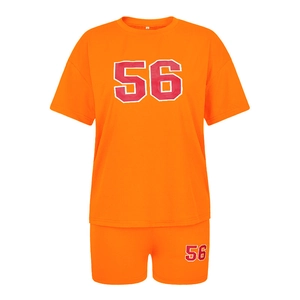 Detail of orange two-piece sportswear set with number 56 print on tee and shorts