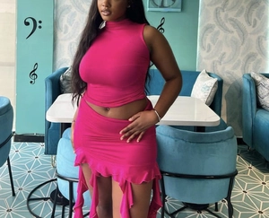 Detail of rose pink sleeveless crop top and matching ruffle mini skirt set for women