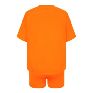 Flat lay of vibrant orange two-piece athletic set featuring crewneck tee and matching shorts