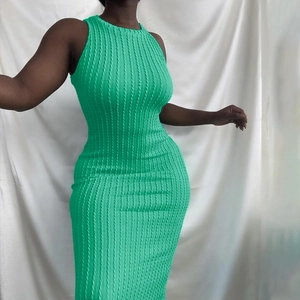 Detail of lime green sleeveless dress showing tight vertical cable knit texture and slim fit