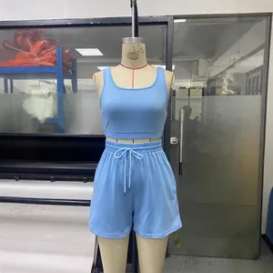 Solid light blue two-piece workout set featuring sleeveless crop top and drawstring shorts