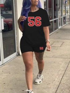 Detail of black sports set with red number 56 print on short sleeve T-shirt and tight shorts