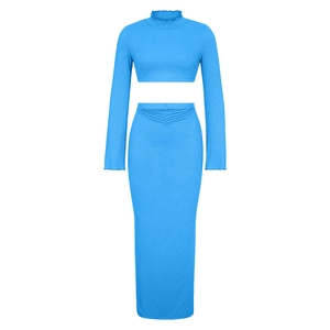 Detail of sky blue ribbed fabric texture and ruffled neckline on this two-piece set