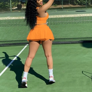 Women's two-piece orange slim fit sports vest and pleated tennis skirt athletic set