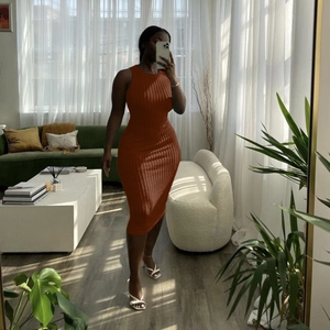 Close-up of caramel sleeveless knit dress with ribbed texture on a slim-fit silhouette