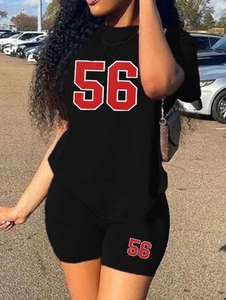 Close-up of black sports two-piece set featuring letter print tee and tight shorts