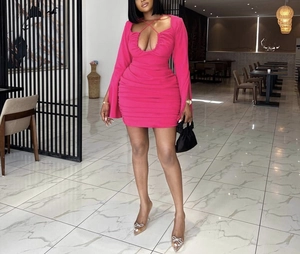 Detail of ruched hot pink slim fit dress featuring deep V neck and lace-up design
