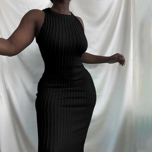 Detail shot of the vertical ribbed knit texture on this slim fit black sleeveless dress