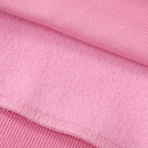 Close-up of soft pink fleece lining and ribbed cuff stitching on a hoodie set